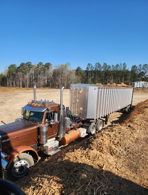 JW Hart Transport truck with walking floor trailer delivering wood mulch