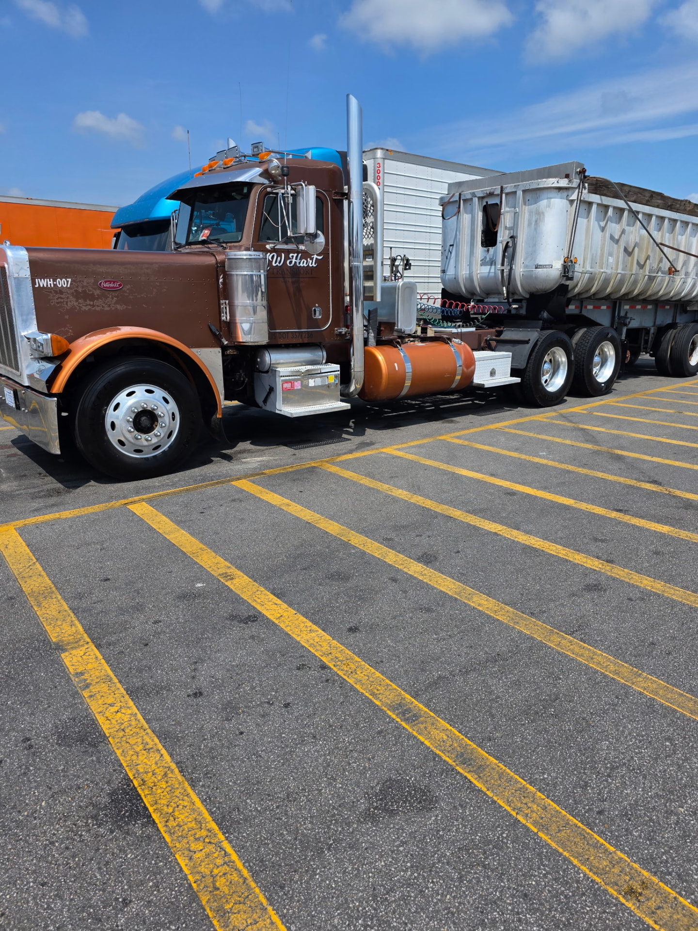 JW Hart Transport JWH-007 brown semi hooked to a silver end-dump trailer in a parking lot