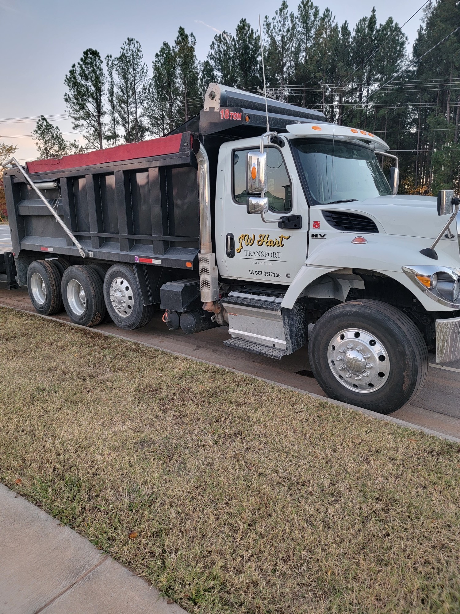 White JW Hart Transport 18-ton dump truck with black and red body