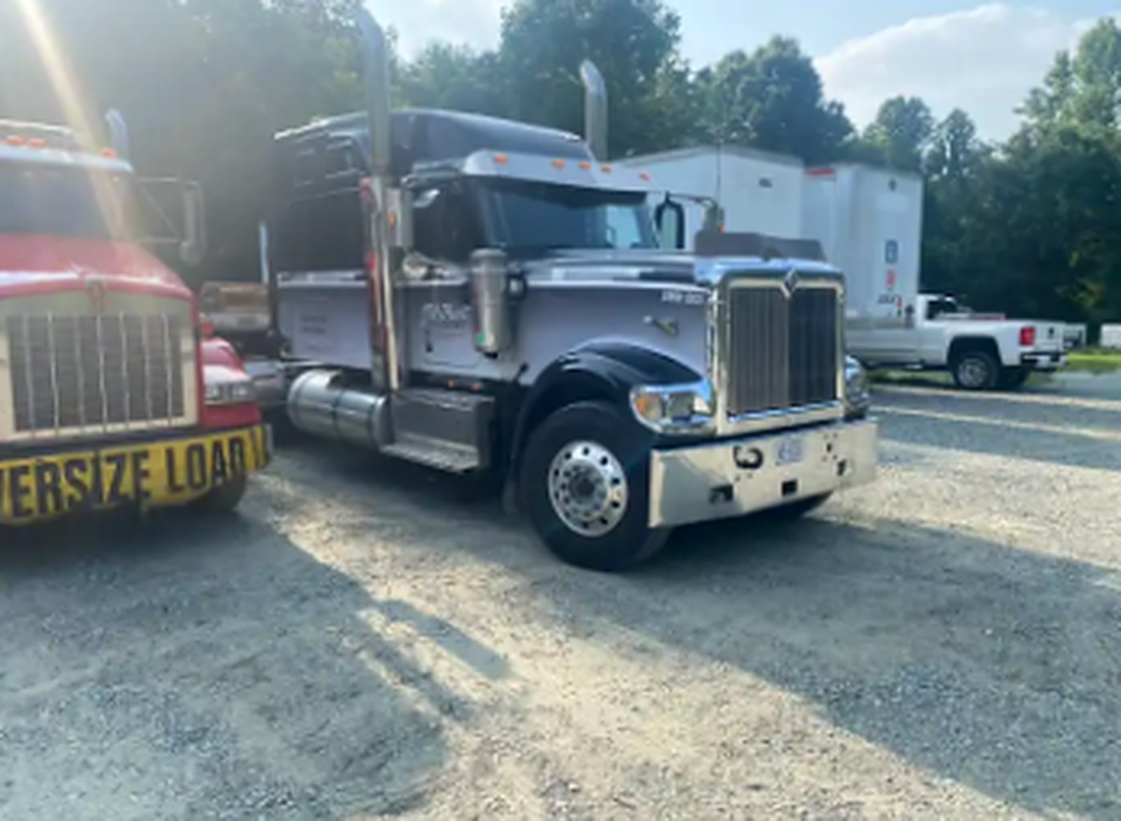 Silver JW Hart Transport semi truck cab parked at the yard